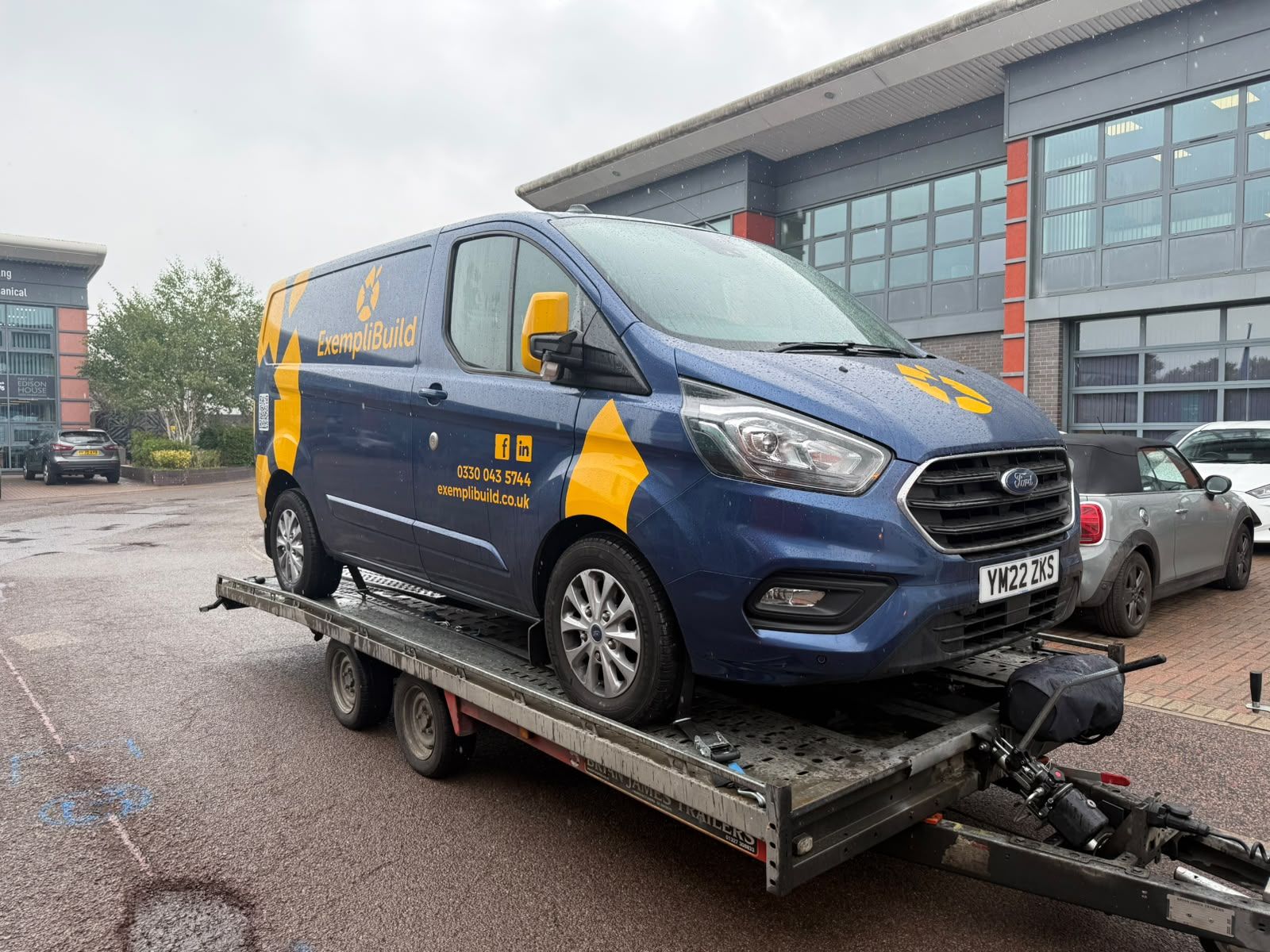Ford Transit Custom van on the SV Transport trailer outside business premises